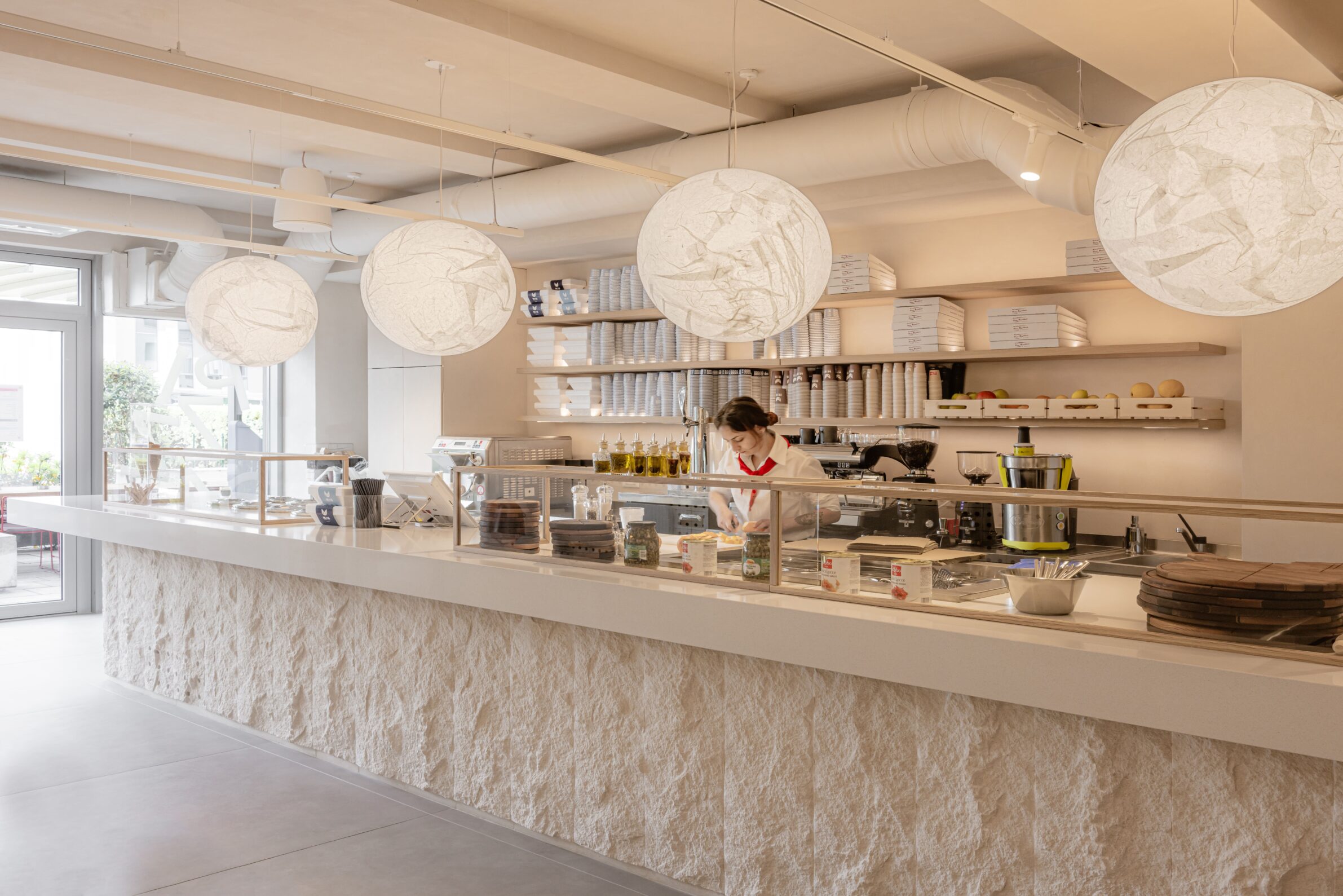 Restaurant MIG by Studio Fluid with an open counter connecting food preparation and dining in Belgrade, Serbia
