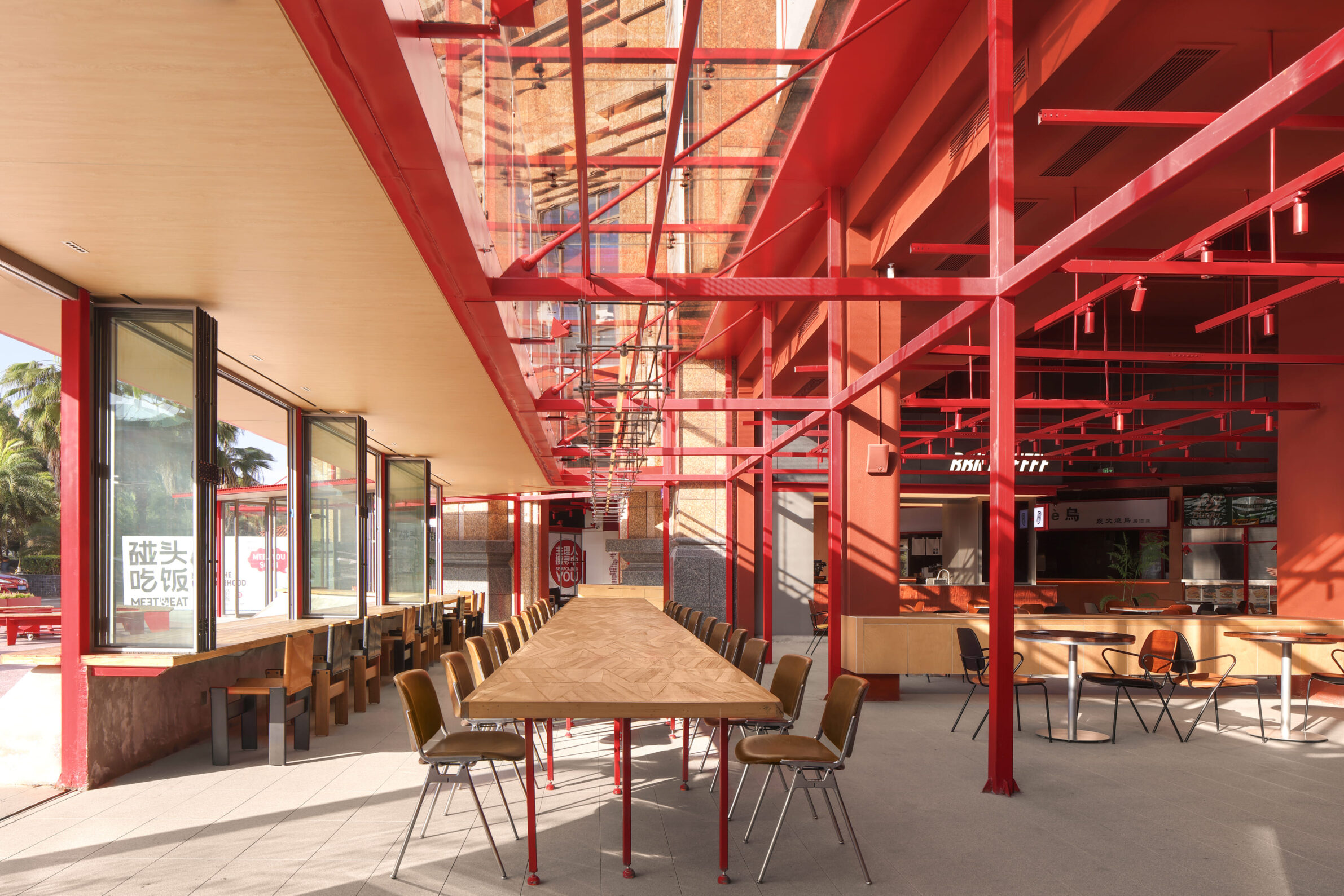 MEET&EAT Hengyang Store by LEL DESIGN STUDIO with a red steel framework connecting the restaurant to the street
