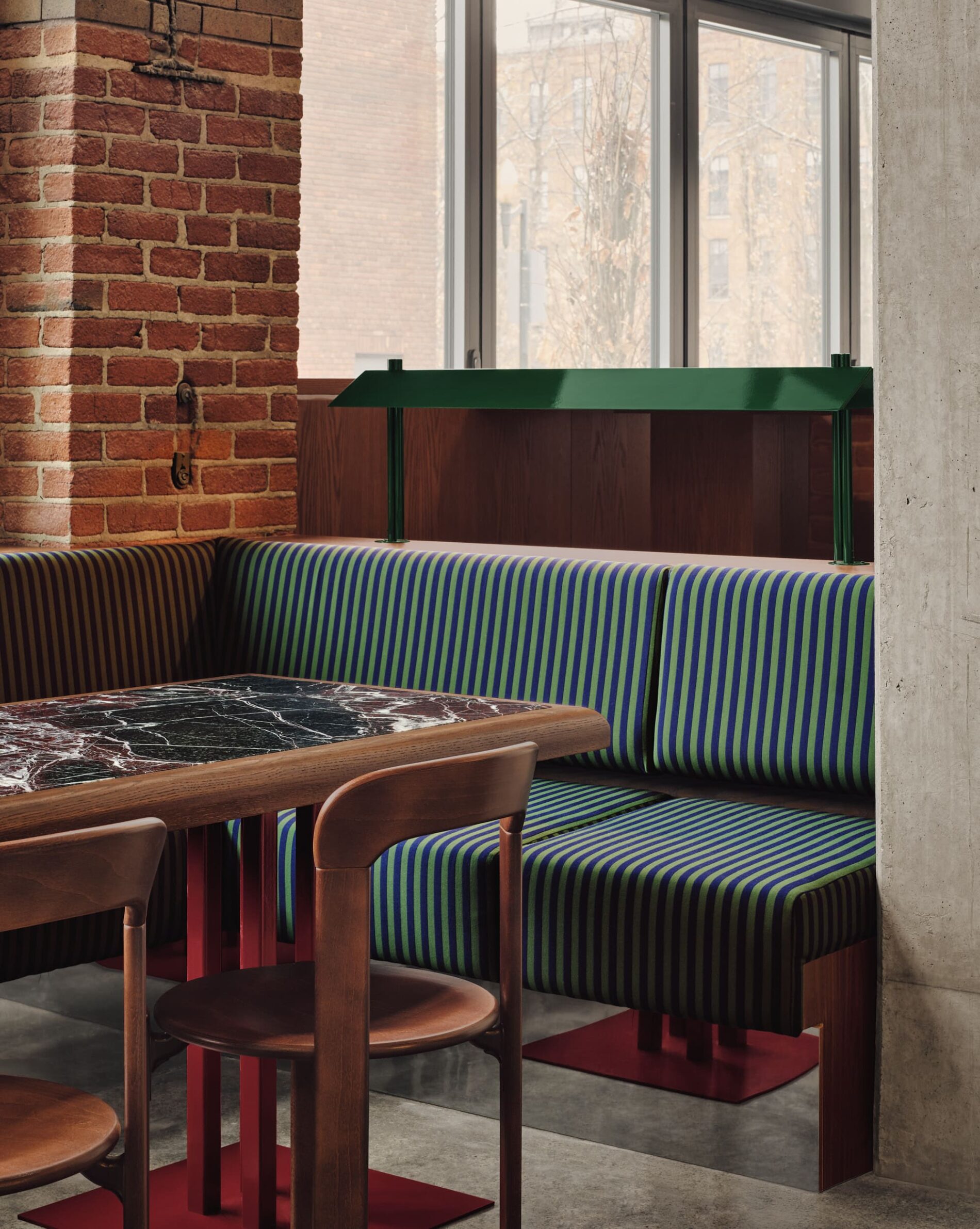 MUNI by IVY Studio inside Montreal’s historic Nordelec building, combining dining, bar and golf lounges