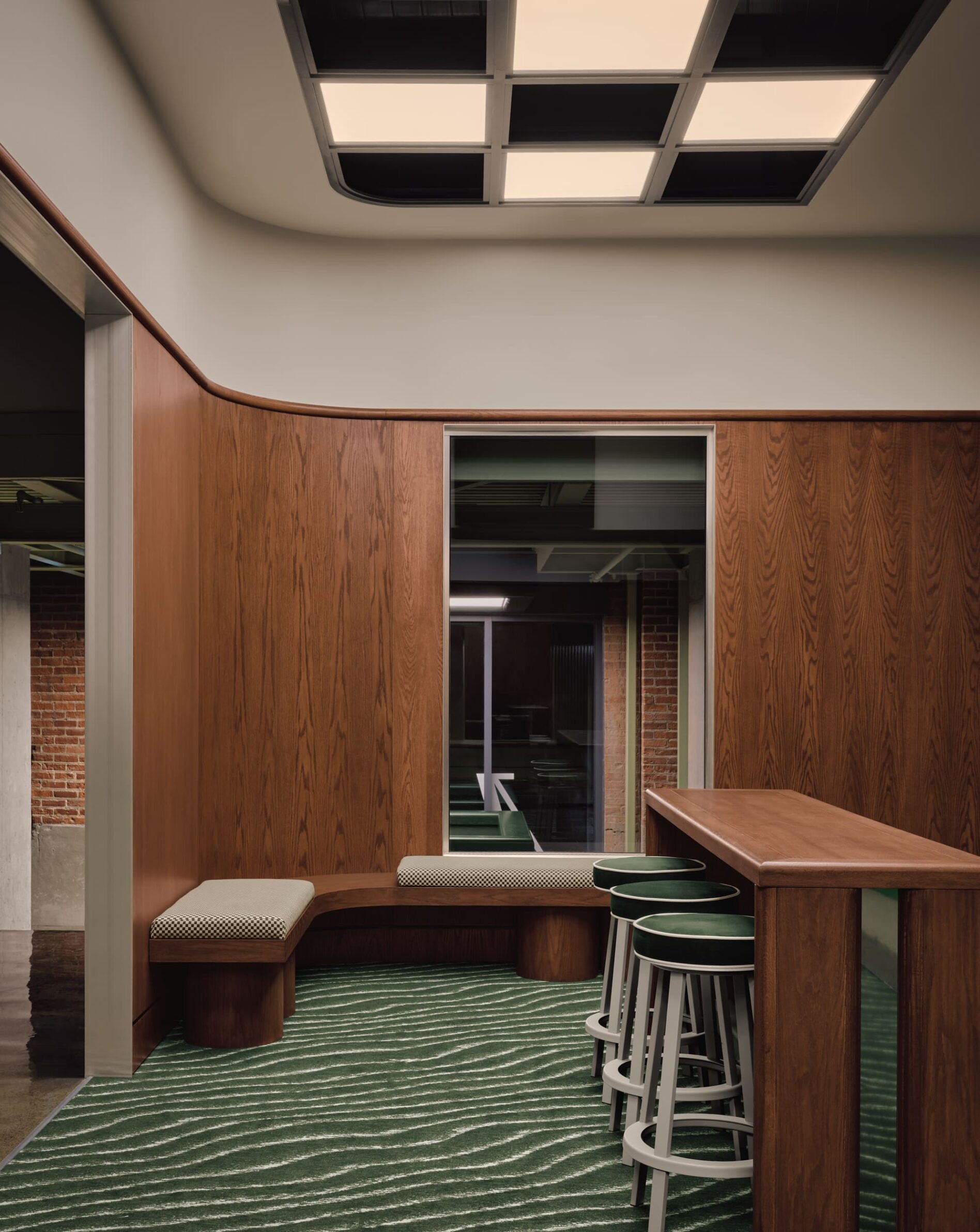 MUNI by IVY Studio inside Montreal’s historic Nordelec building, combining dining, bar and golf lounges