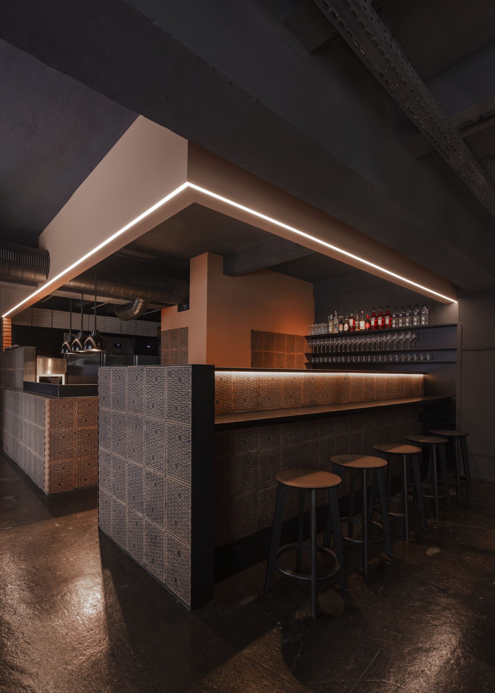 Pizzeria 22K by destilat with a dark interior and red brick bar in Linz, Austria