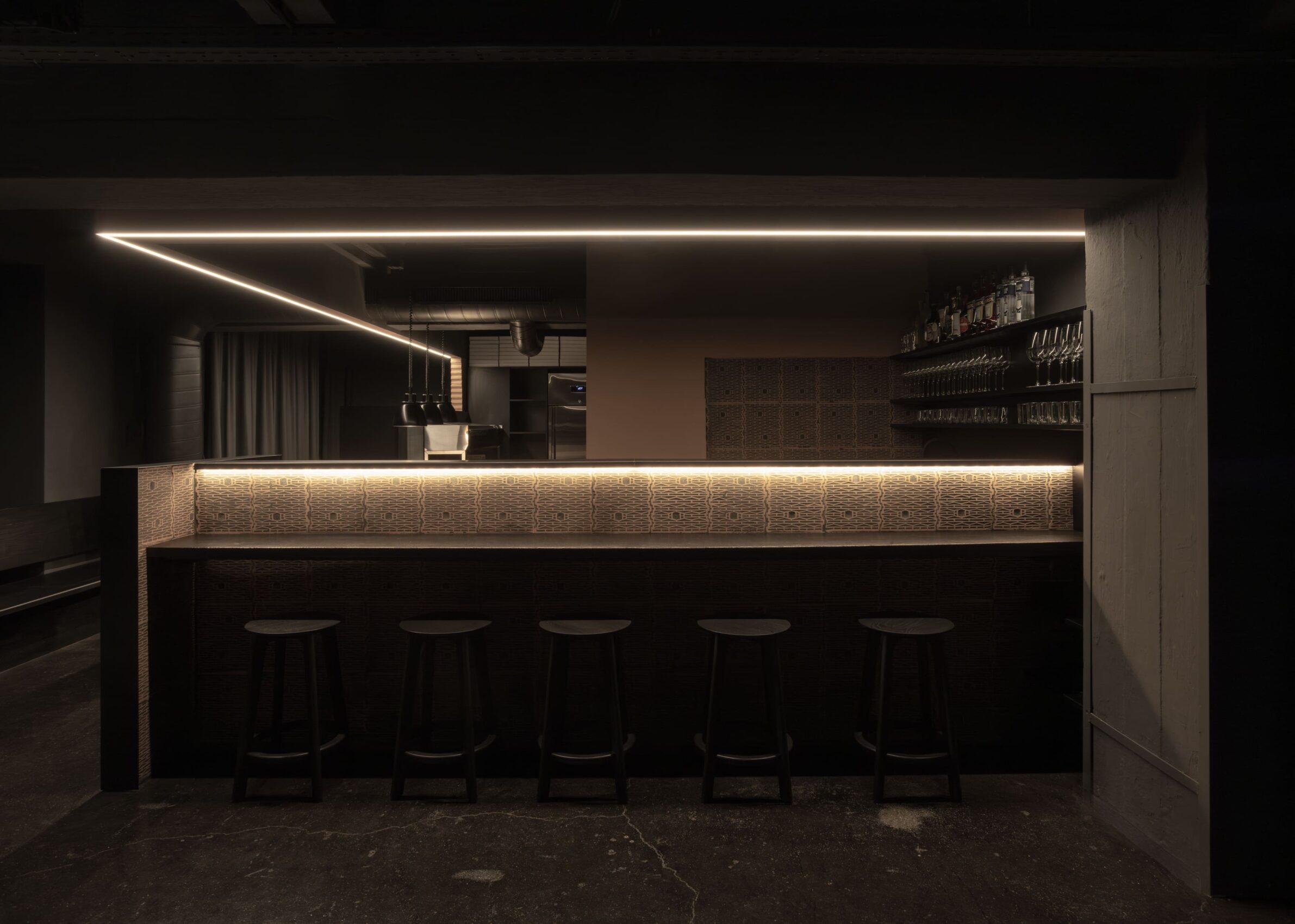 Pizzeria 22K by destilat with a dark interior and red brick bar in Linz, Austria